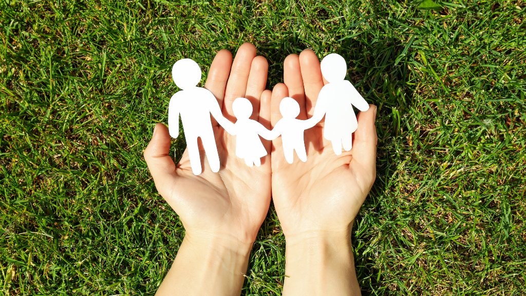 hands holding paper family